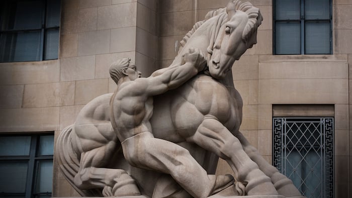 Man Controlling Trade statue in front of the Federal Trade Commission Building